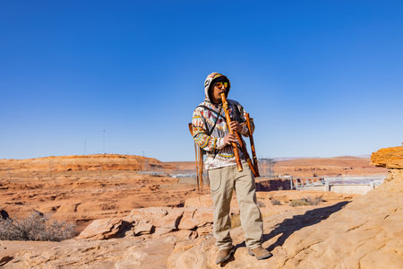 Page, NOV 27, 2020 - Man dress up in traidional clothes doing music performance at Glen Canyon Dam...