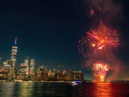Fireworks celebration of July 4th with the famous Manhattan skyline at New Yorkの写真素材