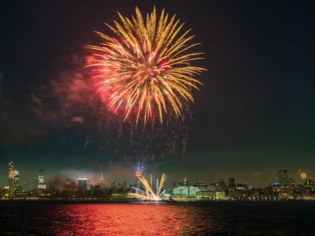 Fireworks celebration of July 4th with the famous Manhattan skyline at New Yorkの写真素材