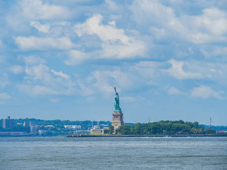 Sunny view of the Statue of Liberty National Monument at New Yorkのeditorial素材