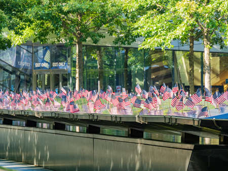 Close up shot of many America flags on the 9/11 Memorial South Pool at New Yorkのeditorial素材