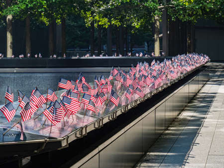 Close up shot of many America flags on the 9/11 Memorial South Pool at New Yorkのeditorial素材