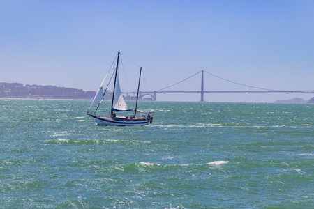 San Francisco, MAY 19, 2021 - Sunny view of a boat and Golden Gate Bridgeのeditorial素材