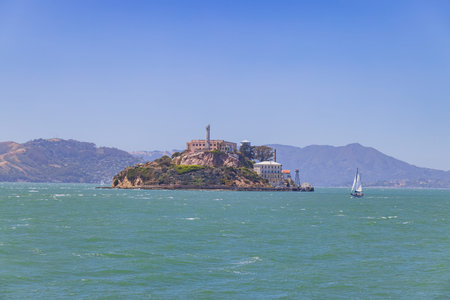 Sunny view of the Alcatraz Island and San Francisco Bay  with a boat at Californiaのeditorial素材