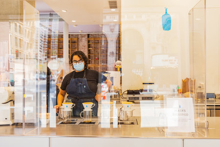 Los Angeles, JUL 24, 2021 - Woman worker is pouring cofee in blue bottle coffee