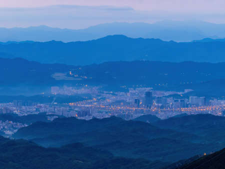 Morning sunrise high angle view of the mountains and cityscape around Wuzhi Shan at New Taipei City, Taiwanの写真素材