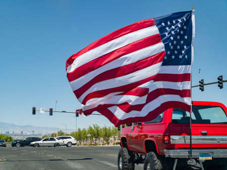 Henderson, APR 17 2021 - Sunny view of a pickup truck with huge America flag swingingのeditorial素材