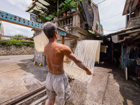 Penghu, Taiwan, JUN 18 2012 - Close up shot of people making the traditional Vermicelli noodleのeditorial素材