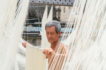 Penghu, Taiwan, JUN 18 2012 - Close up shot of people making the traditional Vermicelli noodleのeditorial素材