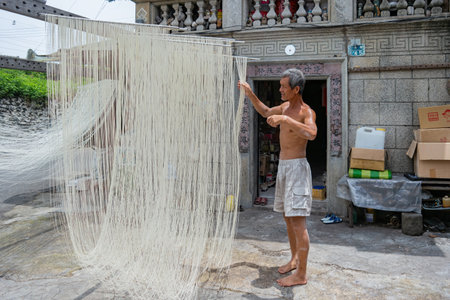 Penghu, Taiwan, JUN 18 2012 - Close up shot of people making the traditional Vermicelli noodleのeditorial素材