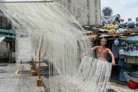 Penghu, Taiwan, JUN 18 2012 - Close up shot of people making the traditional Vermicelli noodleのeditorial素材