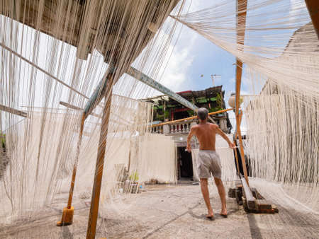 Penghu, Taiwan, JUN 18 2012 - Close up shot of people making the traditional Vermicelli noodleのeditorial素材