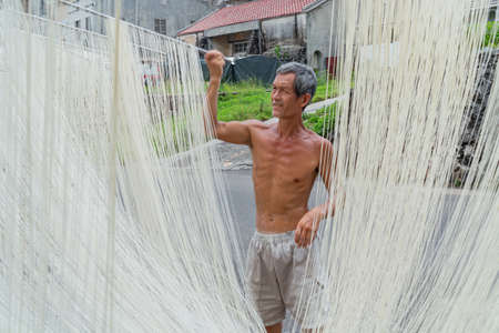 Penghu, Taiwan, JUN 18 2012 - Close up shot of people making the traditional Vermicelli noodleのeditorial素材
