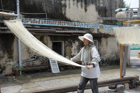 Penghu, Taiwan, JUN 18 2012 - Close up shot of people making the traditional Vermicelli noodleのeditorial素材