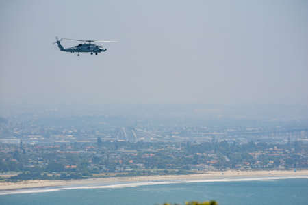 Sunny view of a Military  Helicopter over downtown from Cabrillo National Monument at San Diego, Californiaのeditorial素材