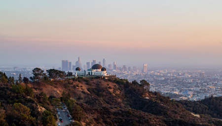 Sunset of the Los Angeles downtown Cityscape with Griffin Observatory at Californiaの写真素材