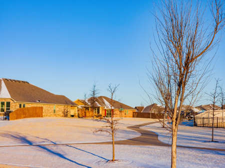 Sunny view of some residence building after a snow storm at Edmond, Oklahomaの写真素材
