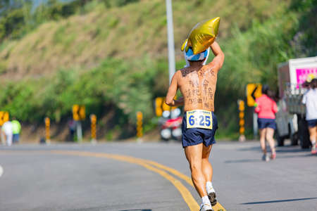 New Taipei, MAR 10 2013 - Close up shot of people running in cherry blossom marathonのeditorial素材