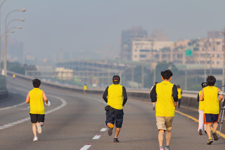 Taipei, MAR 17 2013 - Close up shot of people running in highway marathonのeditorial素材