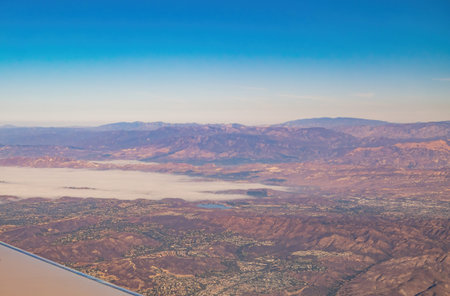 Aerial view of the Angeles National Forest mountain landscape and cityscape at California