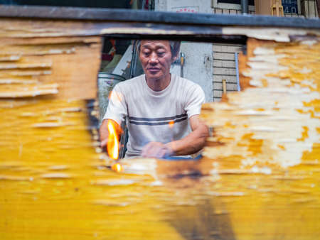 Kinmen, MAY 31 2014 - Close up shot of man grilling  foodのeditorial素材