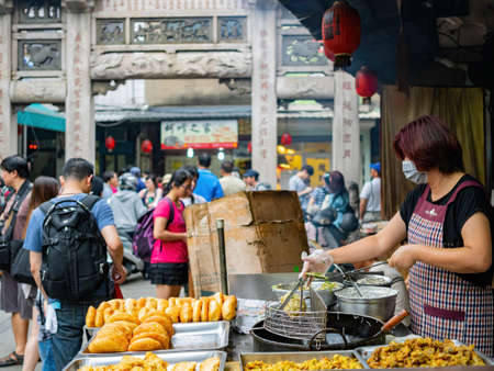 Kinmen, MAY 31 2014 - Close up shot of woman deep frying oysterのeditorial素材