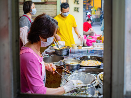 Kinmen, MAY 31 2014 - Close up shot of woman deep frying oyster