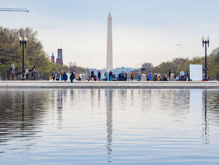 Washington DC, MAR 31 2022 - Overcast view of the Washington Monument with reflectionのeditorial素材
