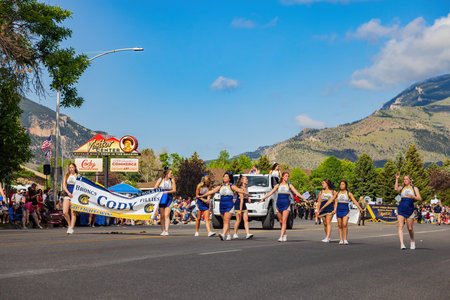 Wyoming, JUL 4 2022 - Sunny view of the Cody High School marching band walking in Cody Stampede Paradeのeditorial素材