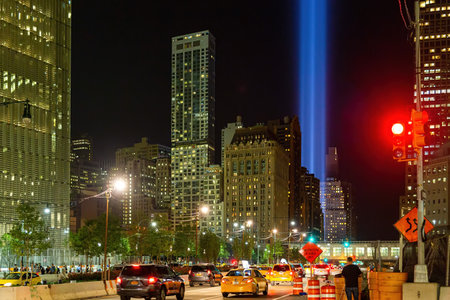 New York, SEP 12 2014 - Night view of the 911 memorial light and the New York City cityscapeのeditorial素材