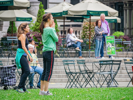 New York, SEP 13 2014 - Many people doing exercise in the Bryant Parkのeditorial素材
