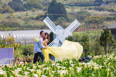 Taipei, AUG 12 2013 - People taking prewedding photowith Zantedeschia blossom in Yangmingshan National Parkのeditorial素材