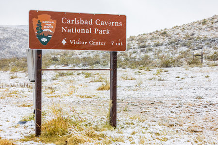 New Mexico, NOV 25 2022 - Admire the captivating beauty of the Carlsbad Caverns National Park sign amidst a blanket of snow on a winter dayのeditorial素材