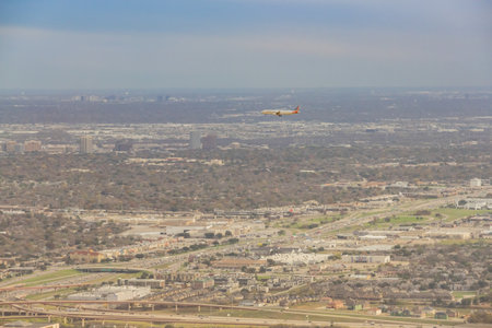 Texas, DEC 14, 2022 - Aerial view of an American airline airplane flying over Dallas cityのeditorial素材