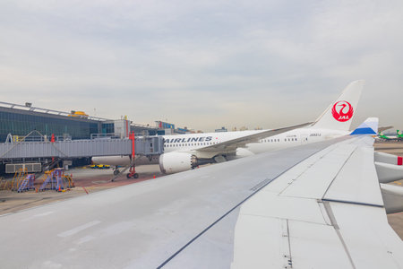 Texas, JAN 9, 2023 - Overcast view of Japan airlines airplane parked at the Taipei Songshan Airportのeditorial素材