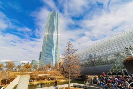 Oklahoma, JAN 21 2023 - Sunny exterior view of the skyscrapper and many people in downtownのeditorial素材