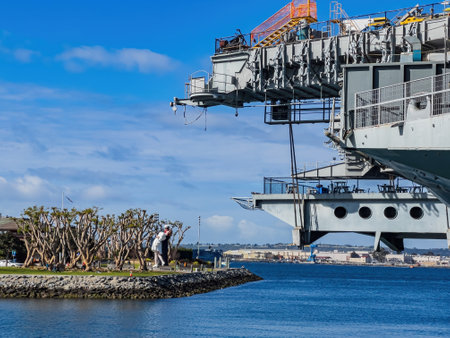 San Diego, FEB 24 2023 - Sunny view of the USS Midway Museum and The Kissing Statueのeditorial素材