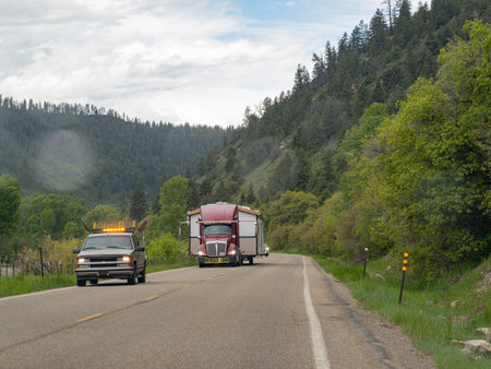 Colorado, JUN 7, 2023 - Big truck is loading with a tiny home on the roadのeditorial素材