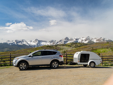 Sunny view of the landscape of Mt Sneffels with a vehicle towing travel trailer at Coloradoの写真素材