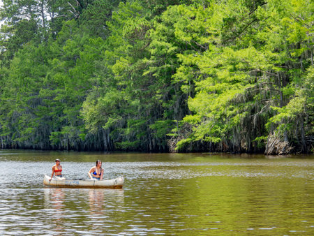 Texas, JUL 1 2023 - Woman playing boat in Caddo Lake State Parkのeditorial素材