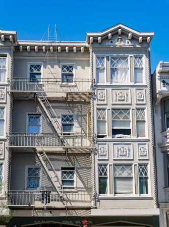 Sunny view of a building with many window and stairs at San Francisco, Californiaの写真素材