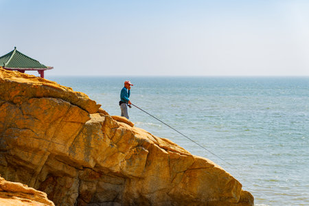 Macao, FEB 2 2014 - People fishing at Hac Sa Long Chao Kok Coastal Trailのeditorial素材