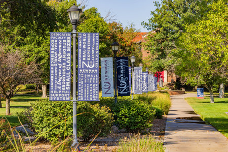 Kansas, SEP 17 2023 - Sunny view of some flags in campus of Newman Universityのeditorial素材