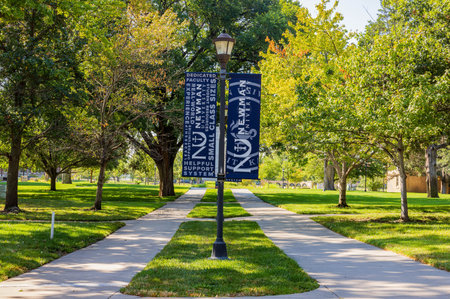 Kansas, SEP 17 2023 - Sunny view of some flags in campus of Newman University