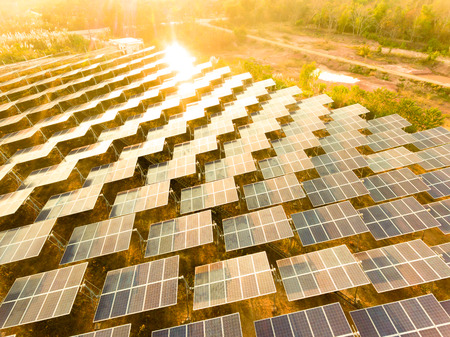 Beautiful sunset over Solar Farm with sunset on the backgroundの写真素材