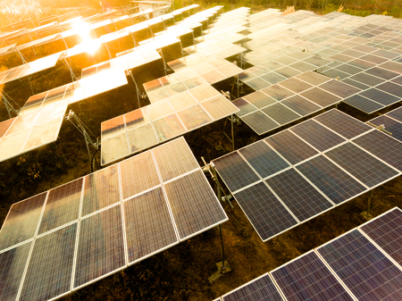Beautiful sunset over Solar Farm with sunset on the backgroundの写真素材