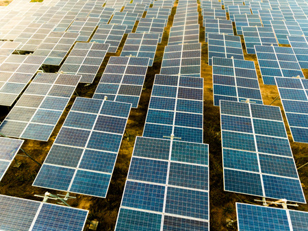 Beautiful sunset over Solar Farm with sunset on the backgroundの写真素材