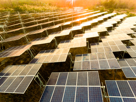Beautiful sunset over Solar Farm with sunset on the backgroundの写真素材