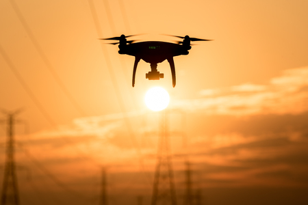 Silhouette of drone flying  at sunsetの写真素材