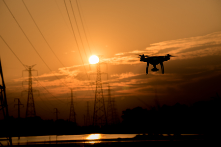 Silhouette of drone flying  at sunsetの写真素材
